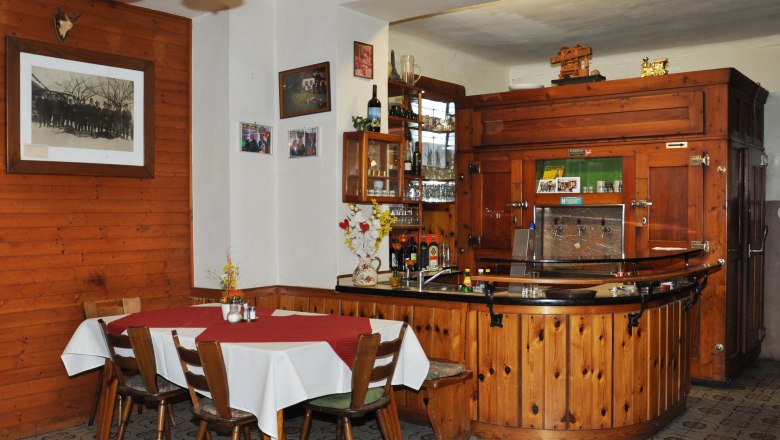 Krumböckhof Inn, © Claudia Alber Interior view of a traditional inn with wooden furniture and bar.