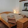 Cozy bedroom with wooden furniture and double bed.