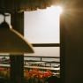 Sunlight streams through the window of the fishing cabin on Schneeberg onto the patio with its benches