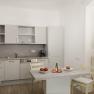 Modern kitchen with gray cabinets, table with apples and drink, open window.