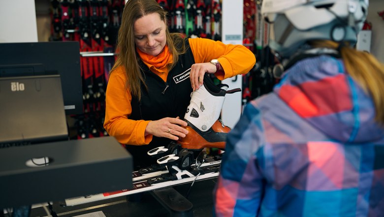 Mitarbeiterin stellt Bindung bei Skiern ein