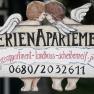 Wooden sign with the inscription 'Ferienapartement' and two angels.