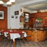 Interior view of a traditional inn with wooden furniture and bar.