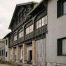Historic facade with a wooden balcony at the Hochschneeberg Mountain Lodge