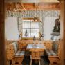 Rustic seating area with a "No Smoking" sign at the Almreserlhaus on Schneeberg
