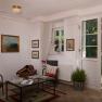 Cozy entrance area with armchairs, table and country-style decorations.