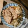 Roast pork with sauerkraut and bread dumplings on a plate at the Edelwei&szlig;h&uuml;tte on Schneeberg