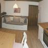 Cozy apartment with kitchen, dining table and sofa.