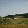 Panoramic view of the Almreserlhaus on the Schneeberg, nestled among rolling hills