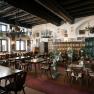 Historic dining room with a tiled stove and wooden ceiling at the Berghaus Hochschneeberg